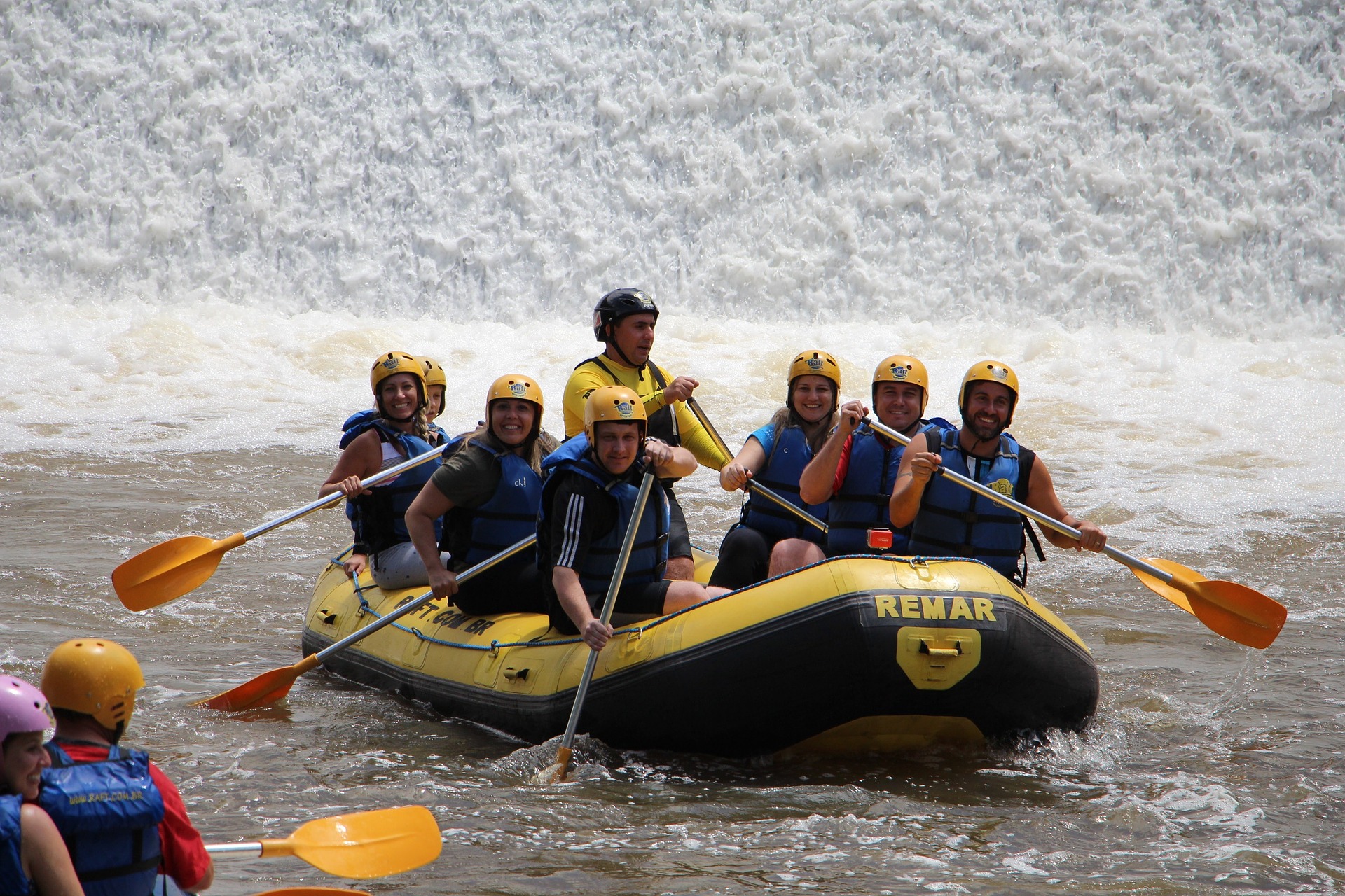 People rafting in a yellow-black boat