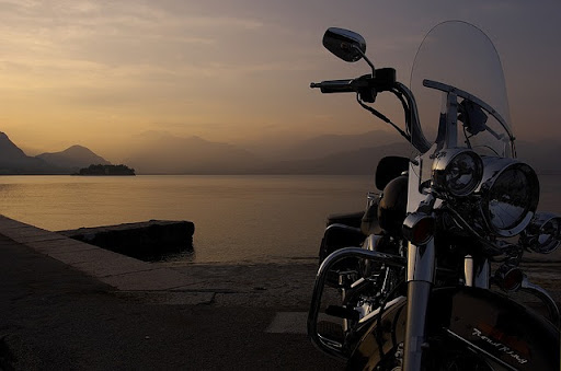 A motorcycle on the beach at late sunset
