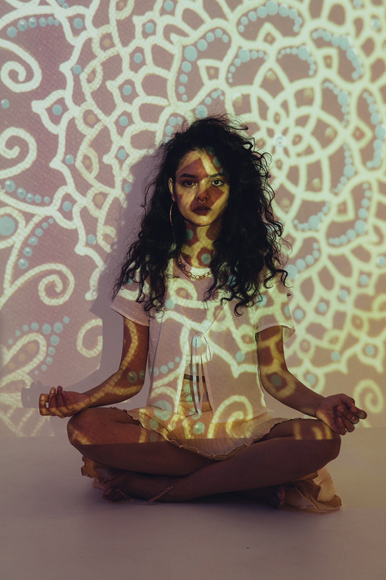 Girl meditating in fractal lights