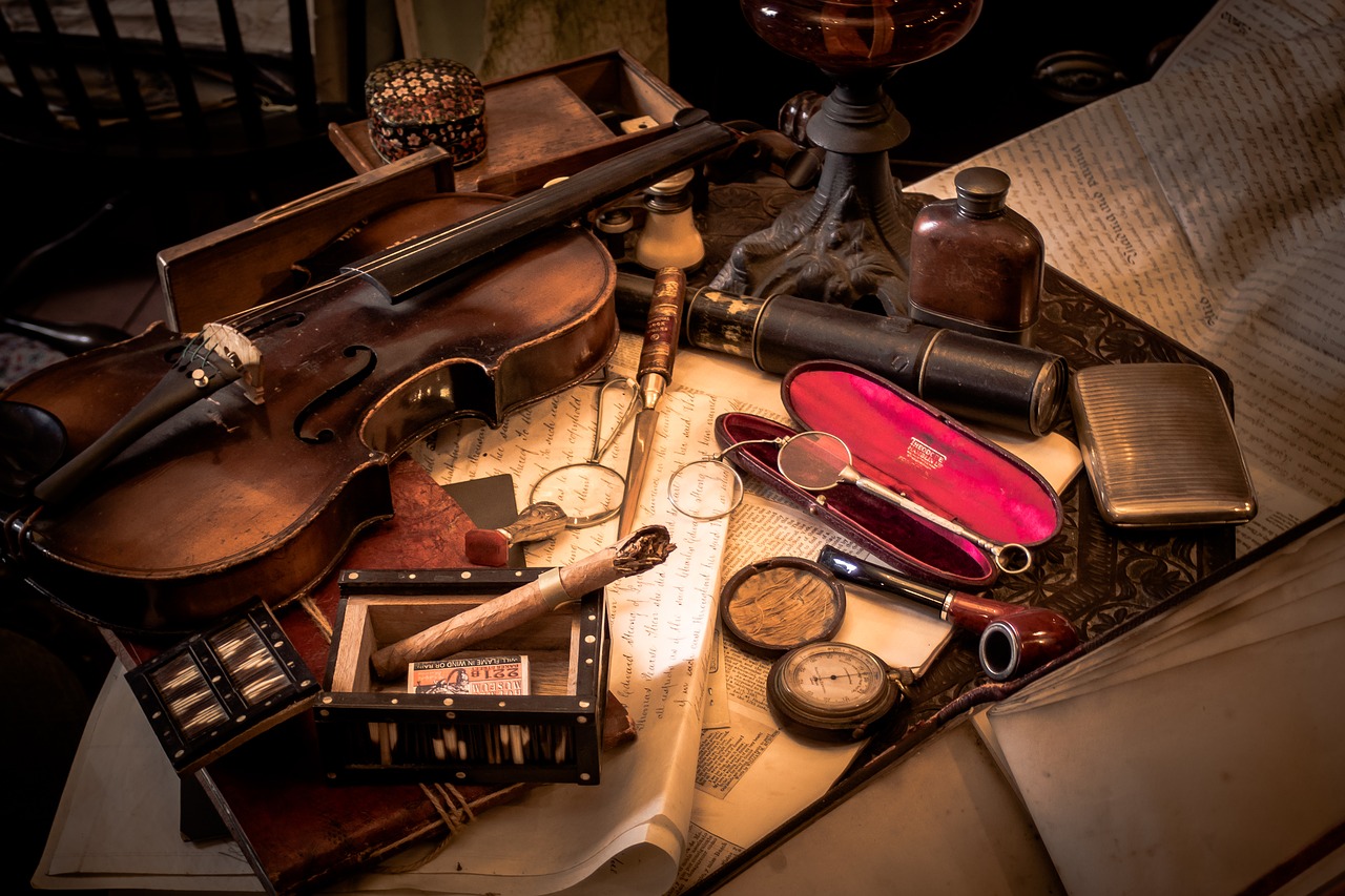  The desk of a detective with a violin, magnifier, compass, papers, and pipes from the 19th century