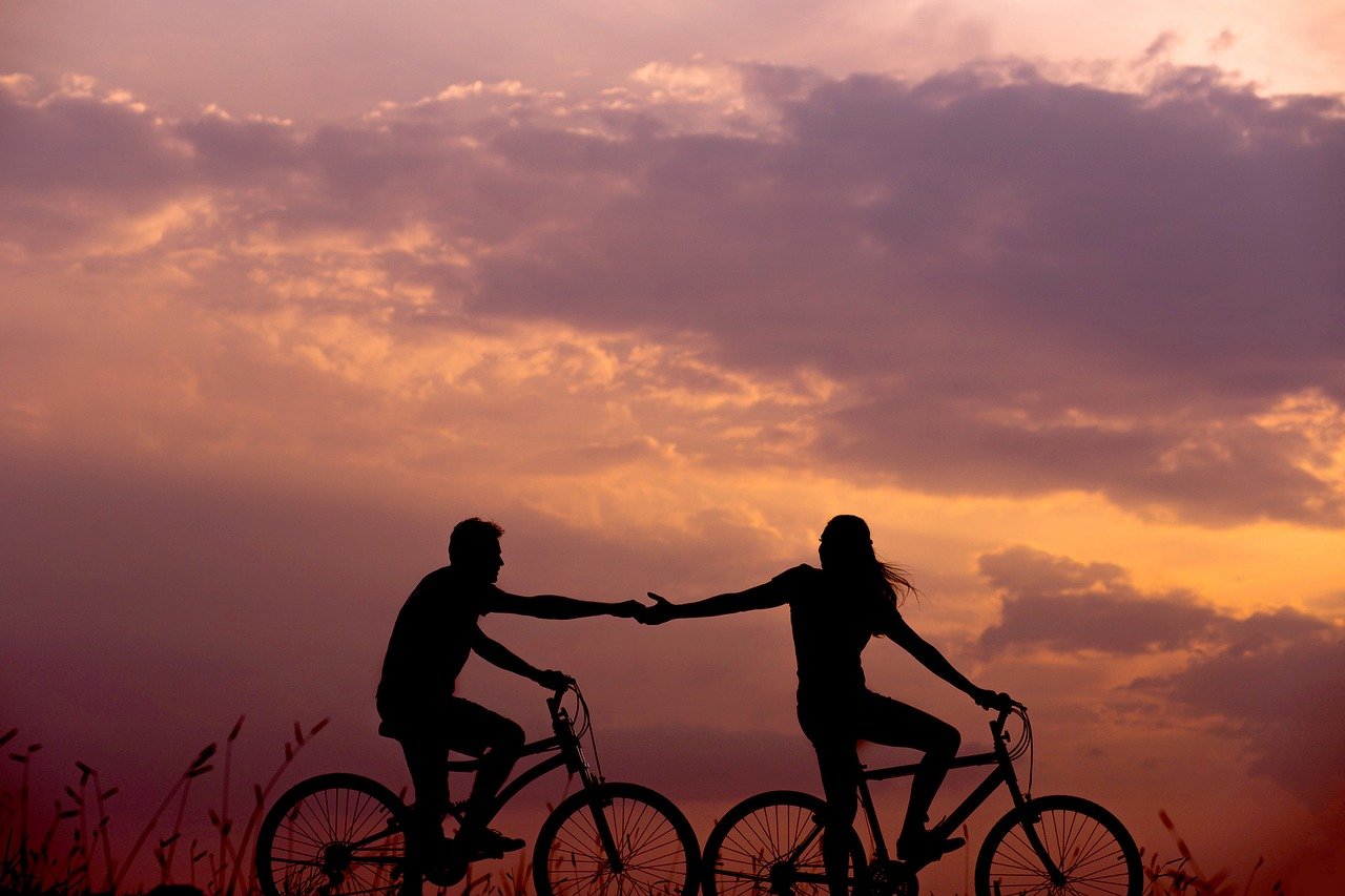  Bicycle riding couple’s silhouette in the sunset