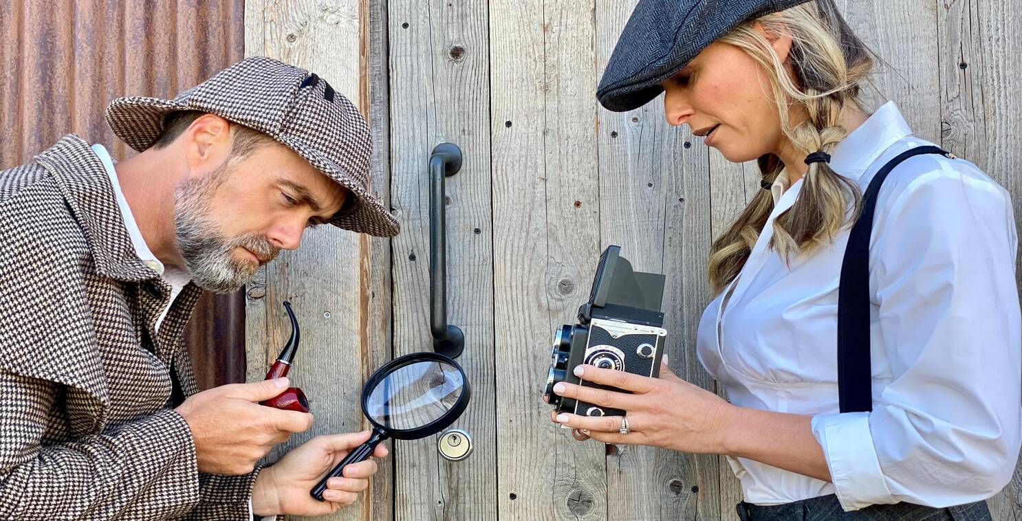 People dressed up as detectives to look for clues in one of the best escape room games