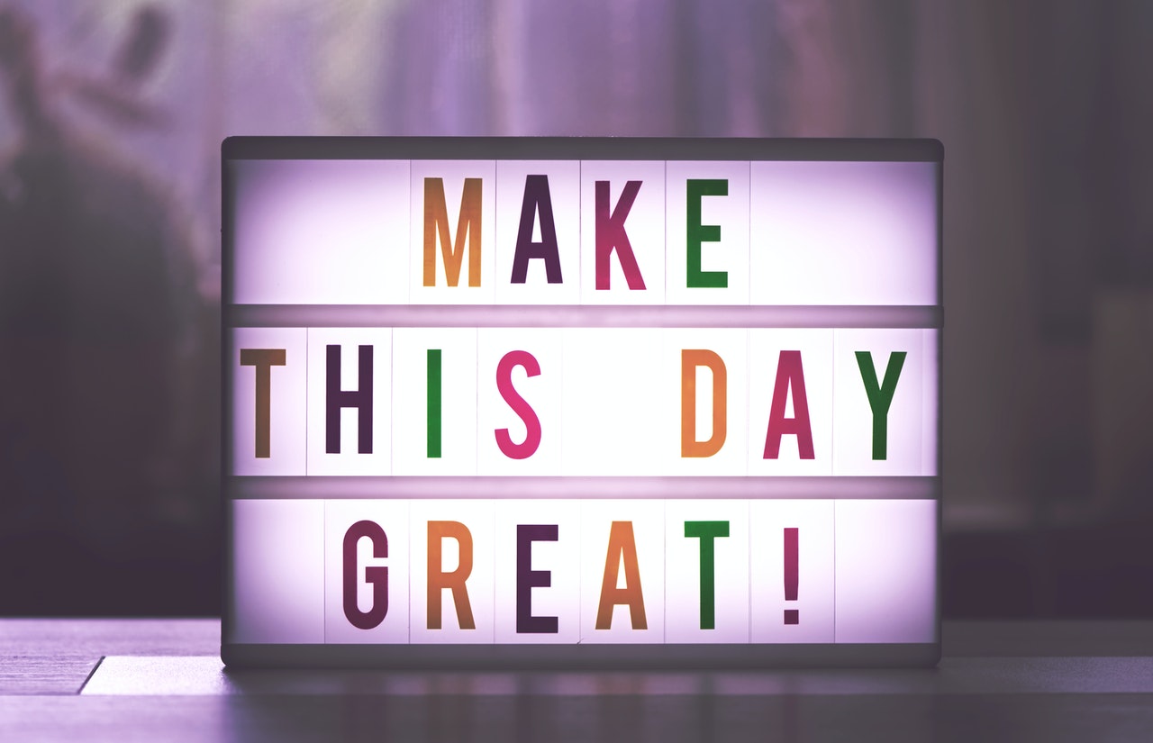 “Make this day great” written on a glowing box