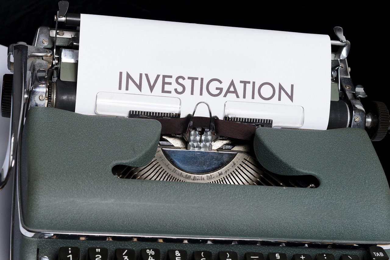 Typewriter with a paper written “INVESTIGATION” on it
