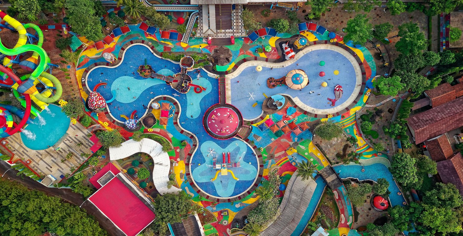Aerial view of a waterpark’s colorful pools. Photo by Tom Fisk